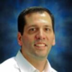 man in white shirt looking at camera